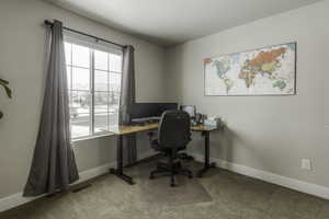 Office area with light colored carpet, visible vents, and plenty of natural light