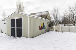 Snow covered structure with fence