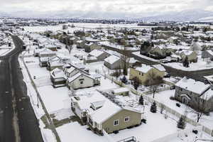 Snowy aerial view with a residential view and a mountain view