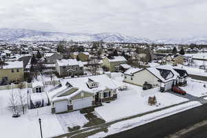 Snowy aerial view with a residential view and a mountain view