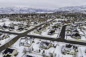 Snowy aerial view with a residential view and a mountain view