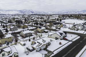 Snowy aerial view with a residential view and a mountain view