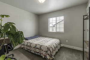 Carpeted bedroom with baseboards