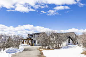 View of front of house featuring a garage, a standing seam roof, and metal roof