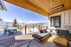 Wooden terrace with outdoor dining area, a mountain view, and outdoor lounge area