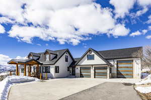 View of front of property featuring stone siding, a standing seam roof, and metal roof