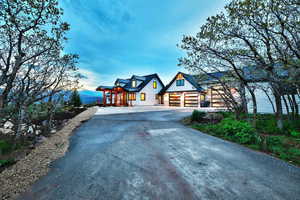 View of front of house featuring a garage and aphalt driveway