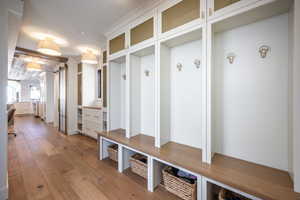 Mudroom with a barn door and light wood-type flooring