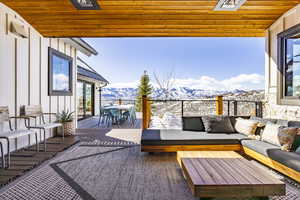 View of patio / terrace featuring a deck with mountain view, outdoor dining area, and outdoor lounge area