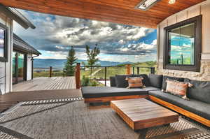 Wooden terrace with a mountain view and an outdoor living space