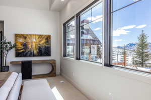 Interior space with plenty of natural light, a mountain view, and baseboards