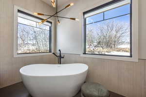 Bathroom with wainscoting and a freestanding bath