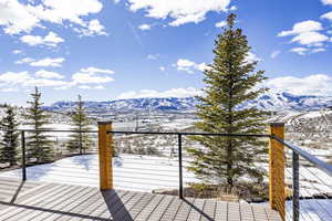 Snow covered deck featuring a mountain view