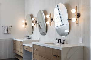 Full bathroom featuring two vanities and a sink