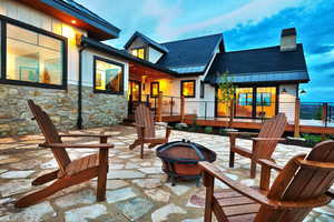 View of patio / terrace with an outdoor fire pit and a deck