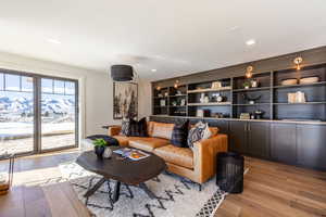 Living area with light wood-style floors and recessed lighting