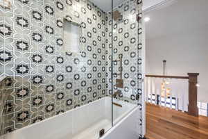 Bathroom with shower / bath combination and wood finished floors