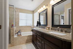 Bathroom featuring a garden tub, tile patterned flooring, a sink, and tiled shower