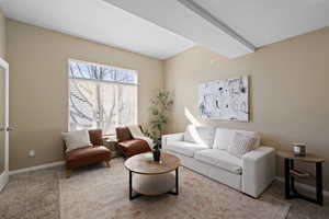 Living area featuring carpet and baseboards