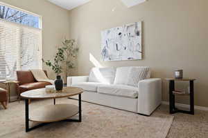 Living room featuring carpet and baseboards