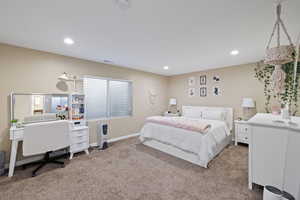 Carpeted bedroom with baseboards, visible vents, and recessed lighting