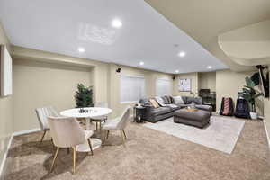 Living area featuring baseboards, carpet, and recessed lighting