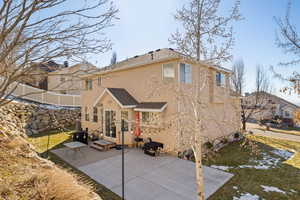 Back of house with roof with shingles, a patio area, fence, and stucco siding