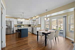 Dining space with visible vents, baseboards, dark wood-type flooring, a chandelier, and recessed lighting