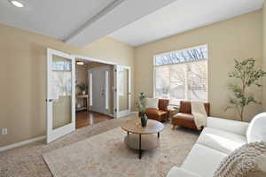 Carpeted living area with a textured ceiling and baseboards