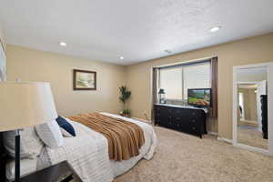 Bedroom featuring recessed lighting, light colored carpet, visible vents, and baseboards