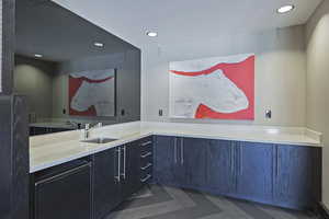 Interior space with light countertops, a sink, and recessed lighting