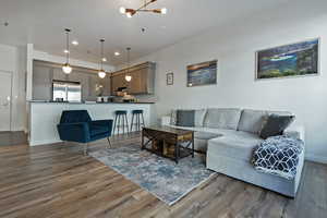 Living area with baseboards, wood finished floors, and recessed lighting