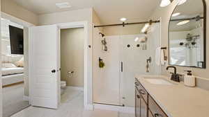 Bathroom with visible vents, toilet, marble finish floor, vanity, and a shower stall