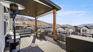 Deck featuring a residential view, a mountain view, and outdoor lounge area