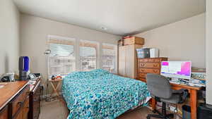 Carpeted bedroom featuring visible vents, baseboards, and a textured ceiling