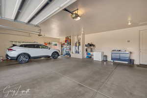 Garage with a garage door opener and strapped water heater