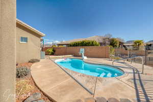 View of pool featuring a fenced in pool, cooling unit, a patio area, and a fenced backyard