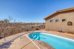 View of pool with a fenced in pool, a patio area, and fence