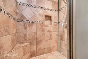 Spacious owners suite with full bath, featuring double vanity, soaker tub, and tiled shower