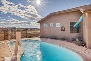 View of pool featuring a fenced in pool and fence