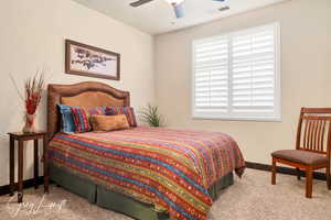 Bedroom featuring a ceiling fan, baseboards, visible vents, and carpet flooring