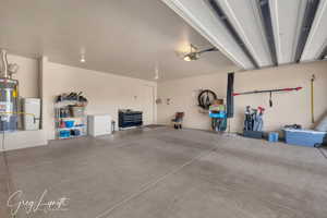 Garage with a garage door opener and secured water heater