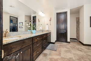 Spacious owners suite with full bath, featuring double vanity, soaker tub, and tiled shower