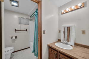 Full bath featuring visible vents, toilet, shower / bath combo, vanity, and tile patterned floors