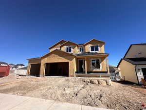 Property under construction featuring an attached garage