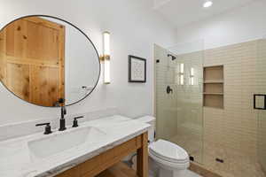 Full bath featuring a stall shower, vanity, toilet, and recessed lighting