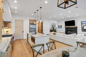 Kitchen featuring light wood-style flooring, stainless steel appliances, a sink, and recessed lighting