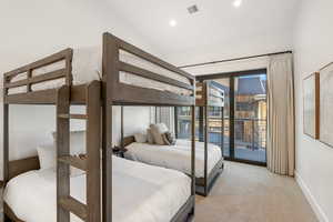 Bedroom featuring light carpet, baseboards, lofted ceiling, access to outside, and recessed lighting