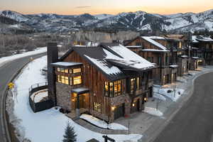 View of front of home featuring stone siding, board and batten siding, and a mountain view