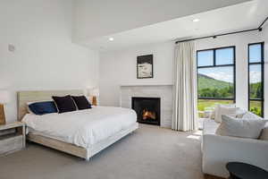 Bedroom with carpet floors, a premium fireplace, and recessed lighting